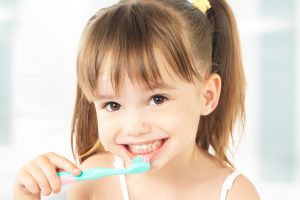 picture of a child brushing her teeth