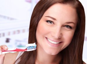 woman with toothbrush and a great smile